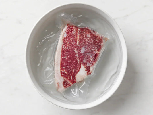 A close-up overhead shot of a vaccum-sealed package of Diamond D Ranch Sirloin