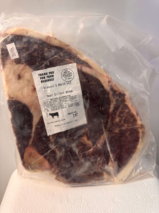 Packaged beef sirloin steak from Diamond D Ranch in vacuum-sealed wrap. Visible marbling, USDA inspected label, and weight of 2.09 lbs.