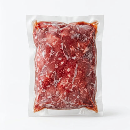 Flash-Frozen grass fed fajita strip in a clear plastic vacuum-sealed bag, photographed against a clean white background.