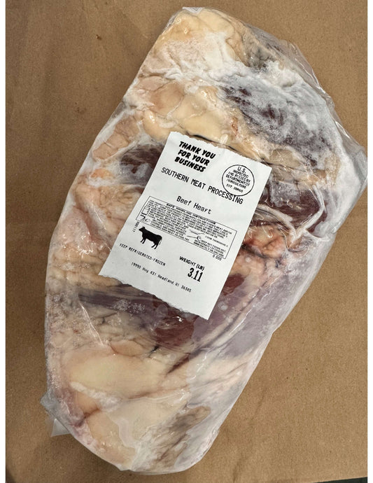 Frozen beef heart in clear packaging with a Southern Meat Processing label, weighing 3.11 lbs, placed on brown paper.
