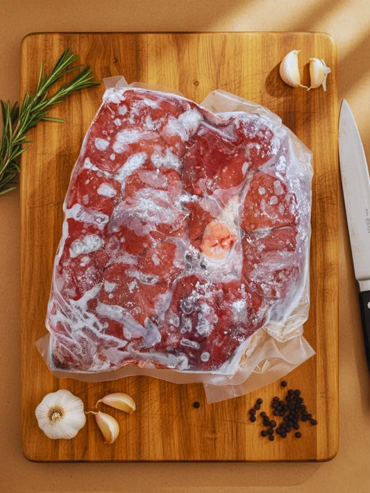 Frozen a beef kidney, grass-fed from Diamond D Ranch. It is in a vacuum-sealed bag on a chopping board