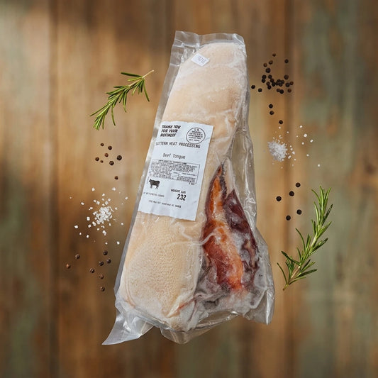 Grass-fed beef tongue in labeled vacuum packaging floating with rosemary and peppercorns