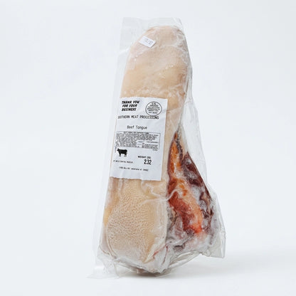 Beef tongue vacuum sealed with weight label, shown upright on a white background