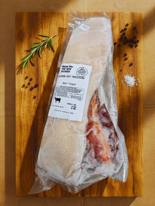 Diamond D Ranch's frozen beef tongue is in a vacuum-sealed package on a brown paper surface.
