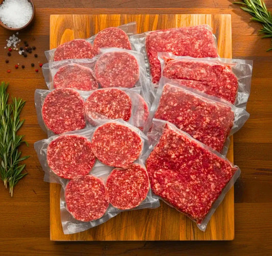 Pack of patties and high-protein ground beef on a chopping board with salt, herbs, and black pepper