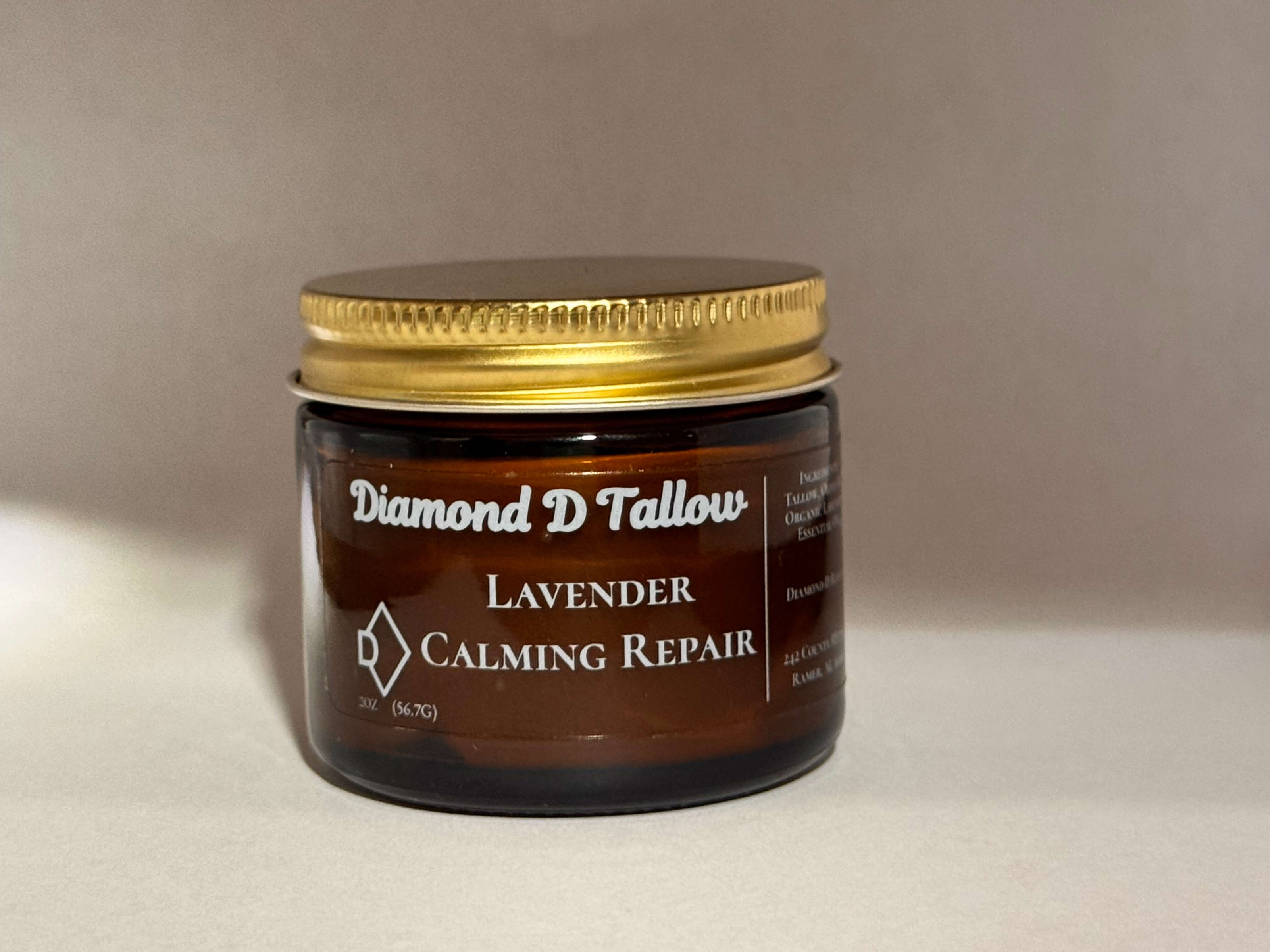 Diamond D Ranch natural skincare whipped tallow balm in a dark brown jar with a gold lid, showcasing light cream.