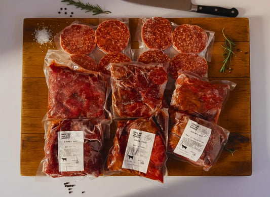 Diamond D Ranch's High-Protein Beef Meal Prep Box is vacuum-sealed in plastic on a wooden board.