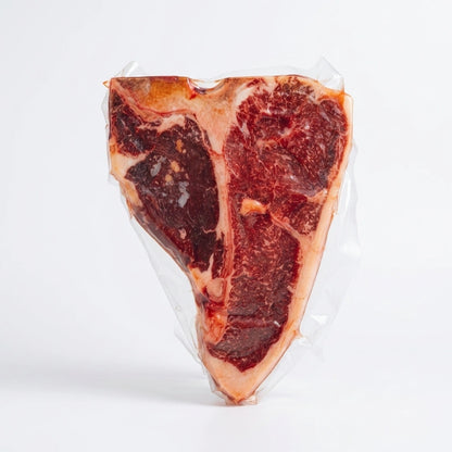 Raw porterhouse steak with T-bone, vacuum sealed on a white background