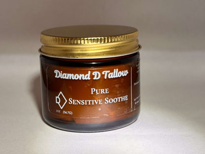 Amber glass jar with a gold lid labeled "Diamond D Tallow Pure Sensitive Soothe." The tone is calming, suggesting a soothing skincare product.