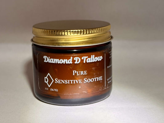Amber glass jar with a gold lid labeled "Diamond D Tallow Pure Sensitive Soothe." The tone is calming, suggesting a soothing skincare product.