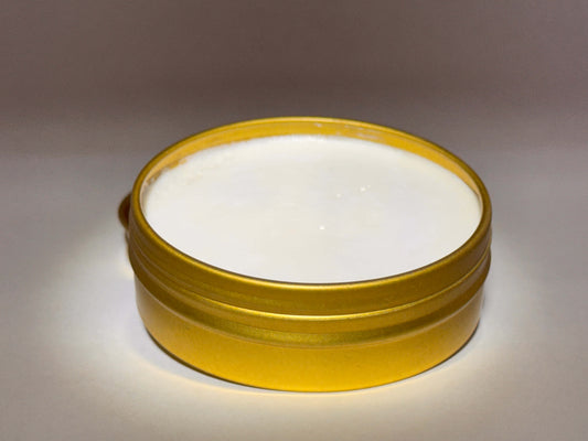 A gold tin labeled "Diamond D Ranch Tallow Sun Balm" which is open-lid with ingredients like tallow, zinc oxide, coconut and jojoba oils, beeswax; 56.7g; Montgomery, AL.